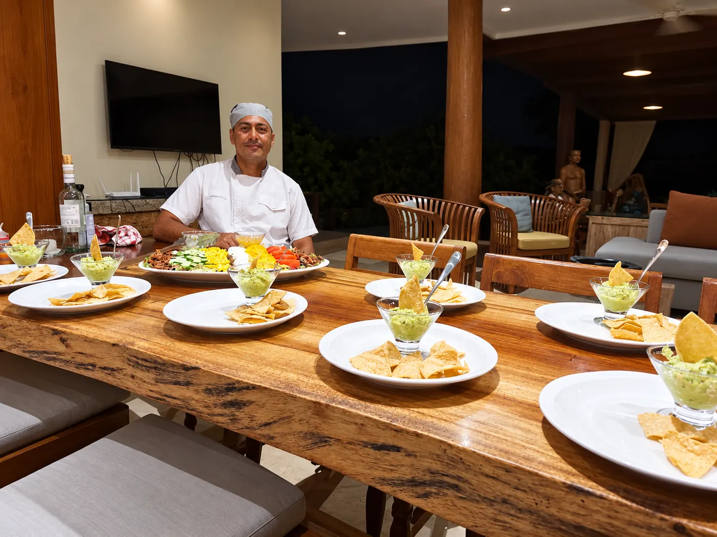 Jorge serving appetizers at a long table in a villa